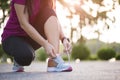 Running shoes - closeup of woman tying shoe laces. Female sport fitness runner getting ready for jogging in garden background Royalty Free Stock Photo