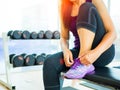 Closeup of woman tying shoe laces. Female sport fitness runner getting ready for jogging in gym Royalty Free Stock Photo