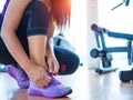 closeup of woman tying shoe laces. Female sport fitness runner getting ready for jogging in gym room Royalty Free Stock Photo