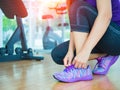 closeup of woman tying shoe laces. Female sport fitness runner getting ready for jogging in gym room Royalty Free Stock Photo