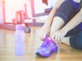 Closeup of woman tying shoe laces. Female sport fitness runner getting ready for jogging Royalty Free Stock Photo