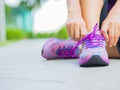 Running shoes - closeup of woman tying shoe laces. Female sport fitness runner getting ready for jogging Royalty Free Stock Photo