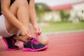 Running shoes - closeup of Young woman tying shoe laces. Royalty Free Stock Photo