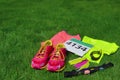 Running shoes, marathon race bib number, runners gear and energy gels on grass background, sport, fitness Royalty Free Stock Photo