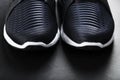 Running shoes with mesh and black and white soles close-up on a dark background. Royalty Free Stock Photo
