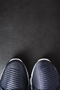 Running shoes with mesh and black and white soles close-up on a dark background. Royalty Free Stock Photo