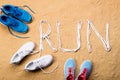 Running shoes and run sign made of shoelaces, sand Royalty Free Stock Photo