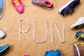 Running shoes and run sign made of shoelaces, sand Royalty Free Stock Photo
