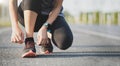 Running shoes runner woman tying laces for autumn run in forest park. Runner trying running shoes getting ready for run. Jogging g Royalty Free Stock Photo