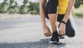 Running shoes runner woman tying laces for autumn run in forest park. Runner trying running shoes getting ready for run. Jogging g Royalty Free Stock Photo