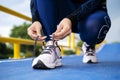 Running shoes runner woman tying laces for autumn run in forest park Royalty Free Stock Photo