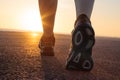 Running shoes in tarmac with sunset