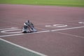 Running shoes and a watch on a athletics track