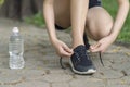 Running shoes - Woman tying shoe laces. Female sport fitness runner getting ready for jogging at garden Royalty Free Stock Photo