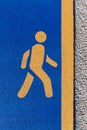 Running sign, yellow running sign on a blue background on a jogging track Royalty Free Stock Photo