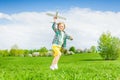 Running small boy holding airplane toy in meadow Royalty Free Stock Photo