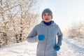 Running sport woman. Female runner jogging in cold winter forest wearing warm sporty running clothing and gloves Royalty Free Stock Photo