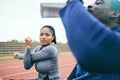 Running, sports and black woman stretching on race track for exercise, marathon training and fitness. Stadium, workout