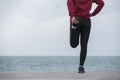 Running stretching before running. Athlete on the seacoast. Royalty Free Stock Photo