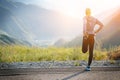 Running stretching. Athlete at the top of the mountain. Royalty Free Stock Photo