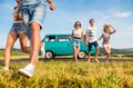 Running teenage couples in love outside against blue sky Royalty Free Stock Photo