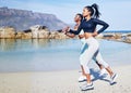 Running together gives us more time to bond. two fit young women out for a run along the beach. Royalty Free Stock Photo