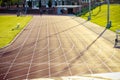 Empty running track backlit by sunlight