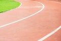 Running track and green field in sport park Royalty Free Stock Photo