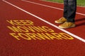 Running track with a motivational quote written, KEEP MOVING FORWARD