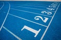 Running track with number. Blue running track in stadium.