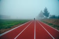 Running track over blue misty sky. Morning run concept photo Royalty Free Stock Photo
