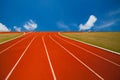 Running track over blue sky and clouds Royalty Free Stock Photo