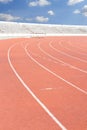 Running track over blue sky and clouds Royalty Free Stock Photo