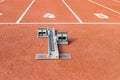 Running track with a starting block in start line number four, close up Royalty Free Stock Photo