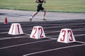 athletics stadium. running tracks at the stadium. the start line on the track against the background of a running girl blurred in Royalty Free Stock Photo