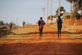 Running training in Kenya. A group of Kenyan runners prepare for a marathon and run on red soil. Marathon running, Track and Field