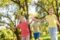 Running two joyful girls with toy and boy