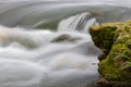 The running water is afraid of hitting the rocks on the shore. Royalty Free Stock Photo
