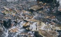 Running water of a mountain stream. Ice cold water and boulders Royalty Free Stock Photo