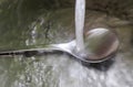 Running water out of a water tap in a metallic kitchen sink Royalty Free Stock Photo