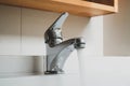 Running water tap, Interior of bathroom with sink basin faucet, Open chrome faucet washbasin. Royalty Free Stock Photo