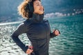 Female runner jogging during outdoor workout on beach Royalty Free Stock Photo