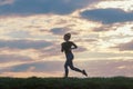 Running woman morning workout. Female Runner. Jogging during sunrise. Workout in a Park. Sporty young woman. Fitness model Royalty Free Stock Photo