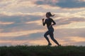 Running woman morning workout. Female Runner. Jogging during sunrise. Workout in a Park. Sporty young woman. Fitness model Royalty Free Stock Photo