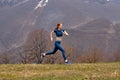 Running woman. Red-haired Female Runner Jogging during Outdoor Workout in nature Royalty Free Stock Photo