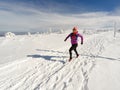 Running woman on winter trail, snow and white mountains