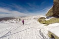 Running woman on winter trail, snow and white mountains