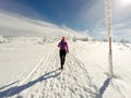 Running woman on winter trail, snow and white mountains