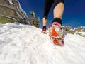 Running woman on winter trail, snow and white mountains