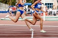 running women track and field team relay race 4 100 metres Royalty Free Stock Photo